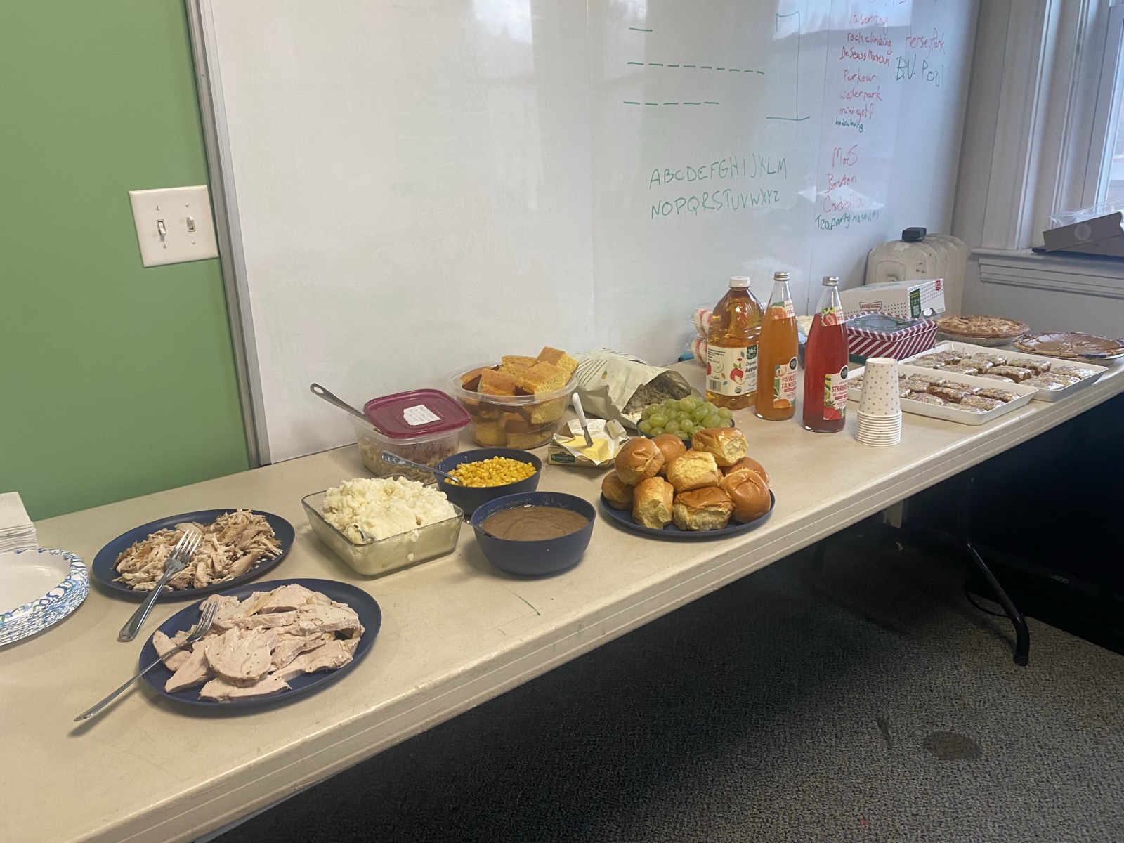 Students and mentors gathered around a table sharing a meal