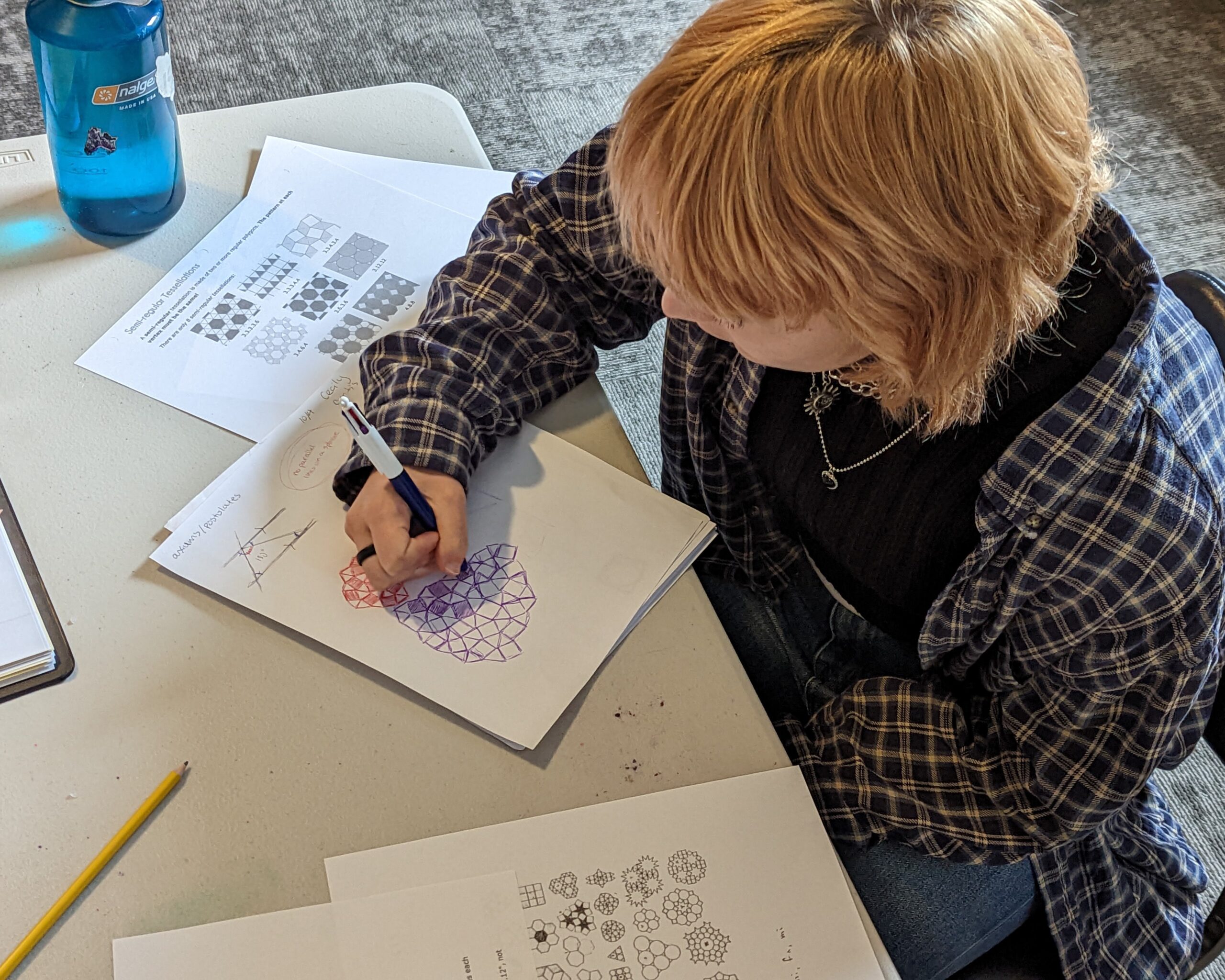 A student working through math problems with a mentor